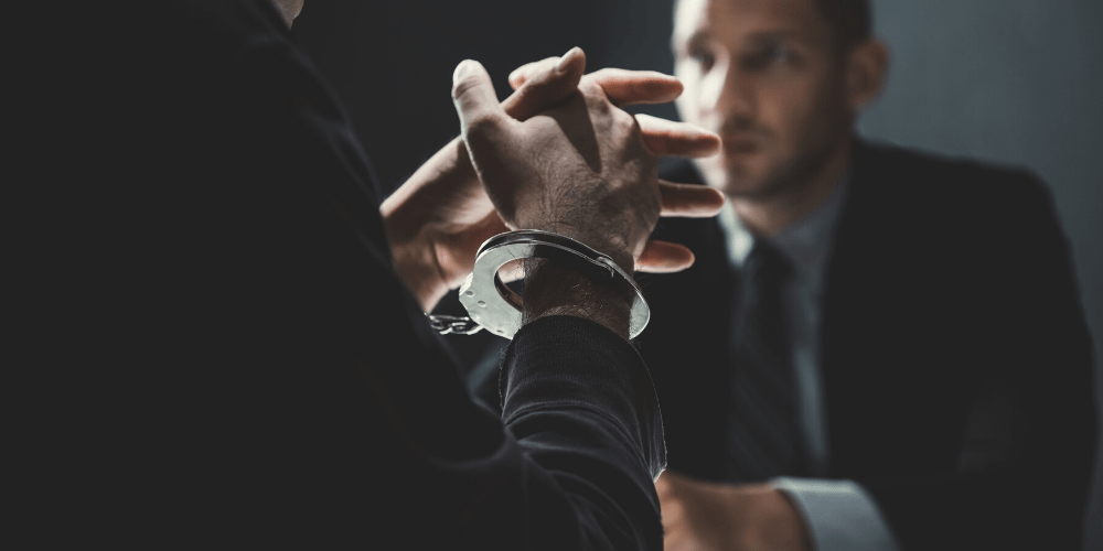 person-in-handcuff-in-meeting-with-lawyer